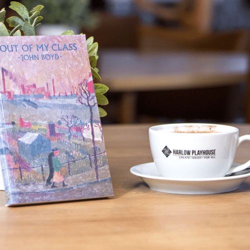 Book and coffee on top of a table with small plant